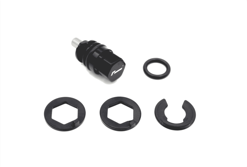 Black plastic tool with several circular, ring-shaped spacers laid out on a white background; includes a small metal/nose piece and multiple hex-like rings for assembly.3a8 // concise description of the kit contents and layout
