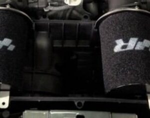 filtre-a-air-racingline-audi-r8-52-v10__604791490375847-1jpeg - OPSHOLDERS Two cylindrical black foam air filters with white branding mounted in a car engine bay.