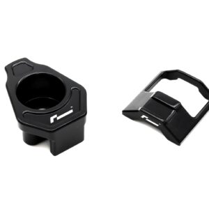 lower-motor-mount-twin-dogbone-inserts_52731172407_o-1jpg - OPSHOLDERS Close-up of two black bicycle pedals, left pedal with a round opening and recessed grip, right pedal with a square cage against a white background