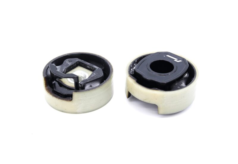 lower-motor-mount-twin-dogbone-inserts_52731701121_o-2jpg - OPSHOLDERS Pair of damaged caster wheels with cracked plastic housings on a white background, showing internal components.