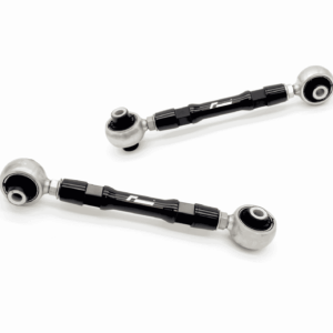 Two black rod-end joints with silver spherical ball joints on a white background, part of a car suspension linkage.