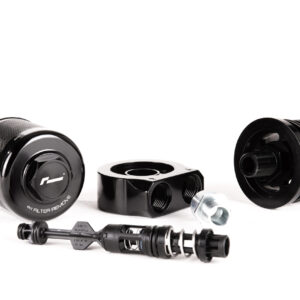 oil-cooler-vwr18-g700_45869747881_o-scaled-1jpg - OPSHOLDERS Disassembled black camera lens parts and metal fittings arranged on a white surface.