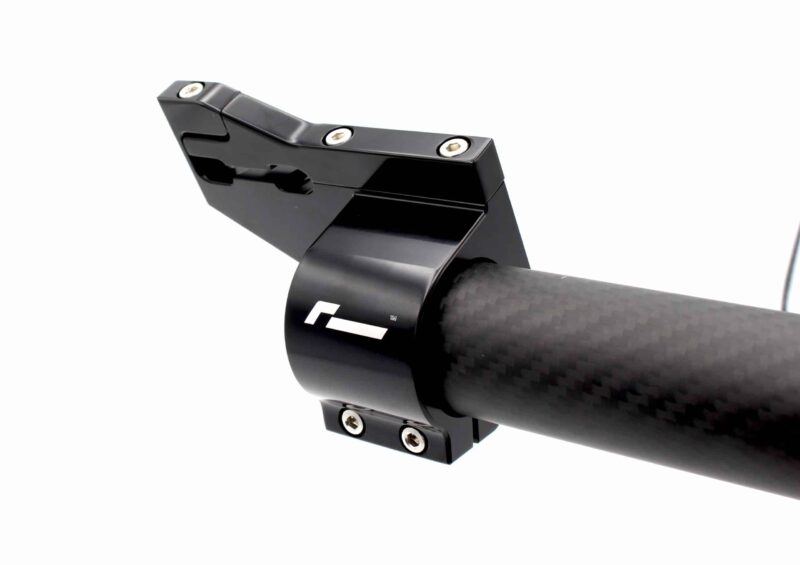 Close-up of a black bicycle stem clamp attached to a carbon fiber handlebar, with several silver screws visible