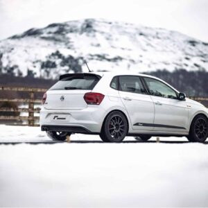 polo-gti-aw-intercooler_53248438794_o-scaled-2jpg - OPSHOLDERS White VW hatchback parked on snow with snow-covered mountains in the background