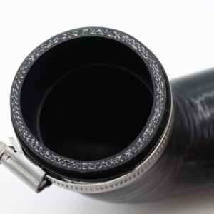 Close-up of a camera lens barrel with a frost-speckled metal ring around the open front element