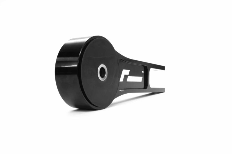Close-up of a black retractable tape measure, showing the round housing and part of the metal blade plate edge outside the case.