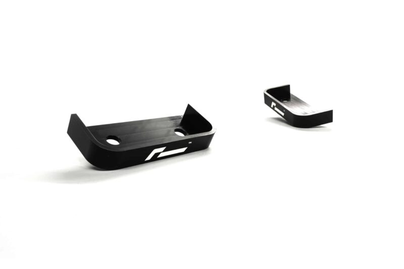 propshaft-bearing-alignment-kit_51767706927_o-scaled-2jpg - OPSHOLDERS Two black metal mounting brackets with curved ends and circular holes, set against a white background.