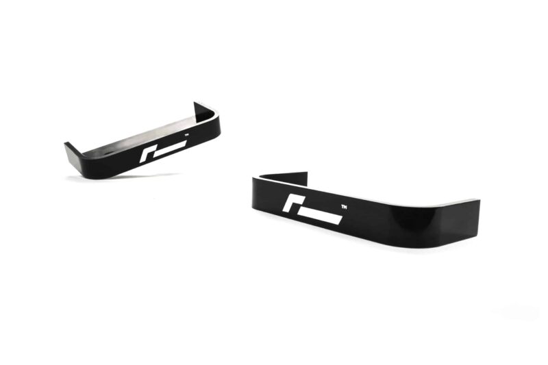 propshaft-bearing-alignment-kit_51768529311_o-scaled-2jpg - OPSHOLDERS Three black curved plastic strips with a white logo, spaced on a white background.