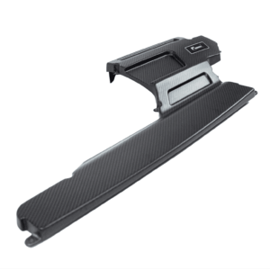 Close-up of a black carbon-fiber bicycle pedal with textured surface and clip-in toe cage, angled diagonally