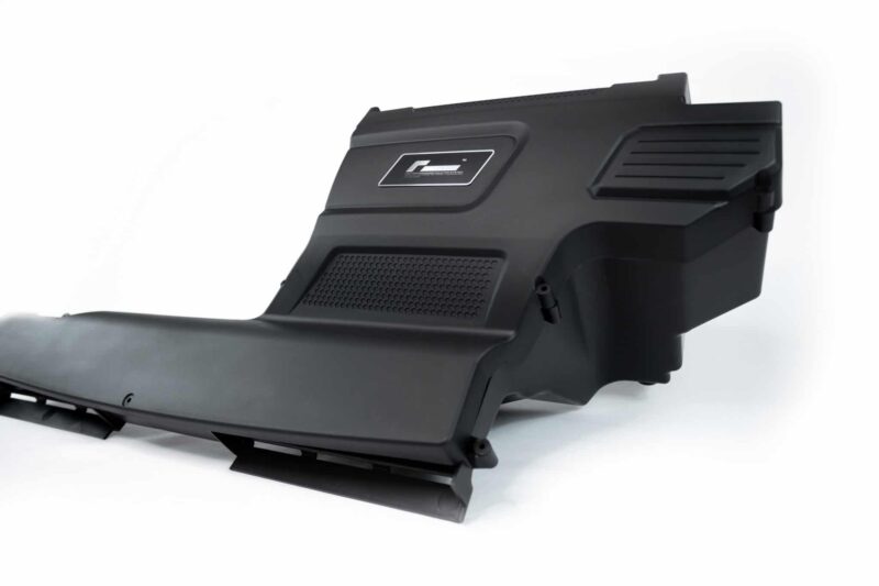 r600-evo-with-new-top-and-base-moulding-for-the-new-mqb-evo-cars_51817361332_o-scaled-2jpg - OPSHOLDERS Close-up of a black rifle stock component with a textured grip and vented surface panels