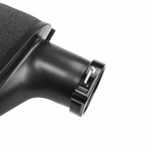 Close-up of a black hair dryer with its nozzle and textured filter visible, angled to the right.