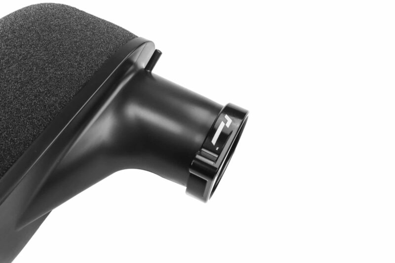 Close-up of a black hair dryer with its nozzle and textured filter visible, angled to the right.