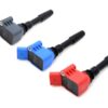 racing-igitnion-coils-high-outputjpg - OPSHOLDERS Three automotive ignition coils in gray, blue, and red with black connectors laid diagonally on a white background.