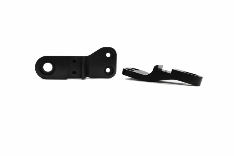racingline-front-subframe-brace-11_51826108408_o-scaled-2jpg - OPSHOLDERS Two black metal brackets with circular holes, lying on a white background (hardware mounting parts).