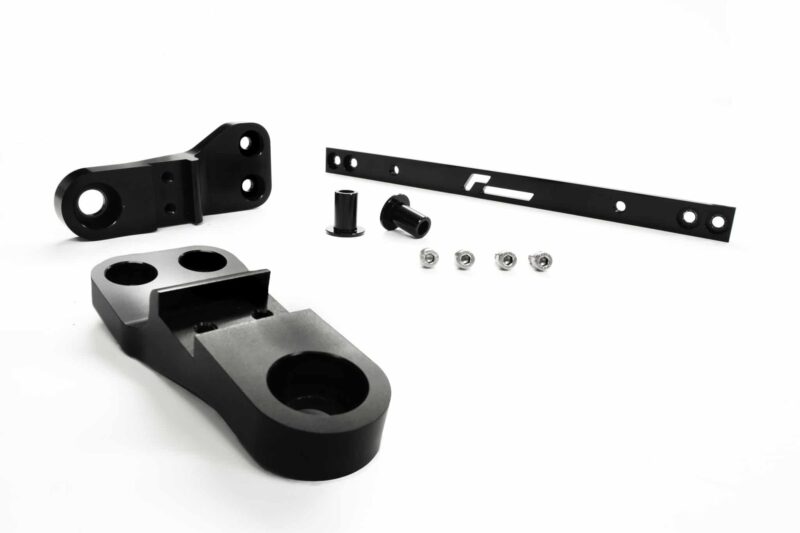 racingline-front-subframe-brace-12_51826343259_o-scaled-2jpg - OPSHOLDERS Assorted black metal hardware parts laid out on a white background, including a curved bracket, a perforated strip, bushings, and screws.