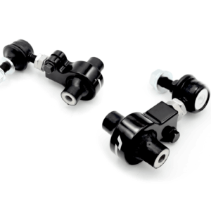 Black metal pneumatic fittings with nuts and bolts laid on a white surface (angled shot)