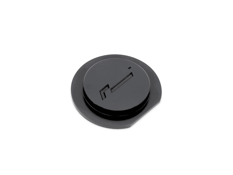Black circular control knob with a horizontal slot, viewed from above (top-down angle)