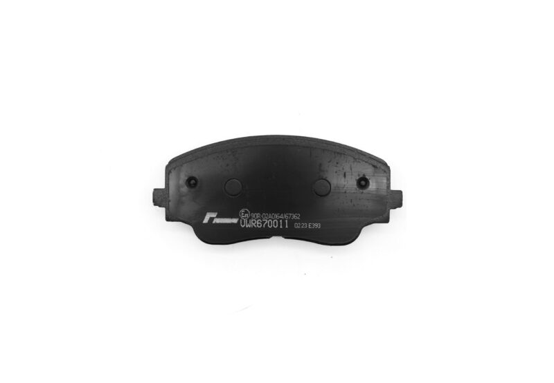 Curved brake pad with visible wear surface and stamped codes on the metal backing plate.