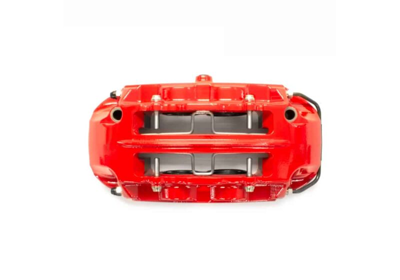Red toy car viewed from above, showing its open interior and chrome axles/suspension details