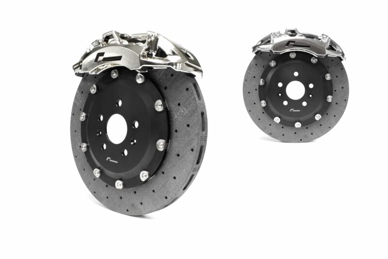 stage-3-ccm-brake-kit_50585982268_o-scaled-2jpg - OPSHOLDERS Pair of ventilated brake rotors with silver calipers displayed against a white background, automotive part shot for a catalog moment.