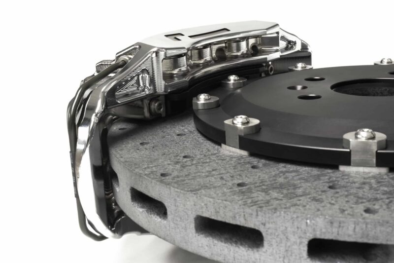 stage-3-ccm-brake-kit_50585982583_o-scaled-2jpg - OPSHOLDERS Close-up of a hard disk drive's read/write head assembly over the spinning platter surface.