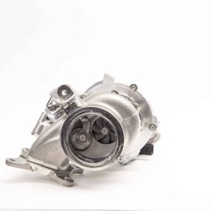 Close-up of a metallic automotive turbocharger housing with visible turbine blades and mounting flanges against a white background
