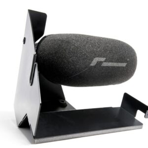 Close-up of a black foam-covered microphone mounted on a metal stand (podcast/recording setup).