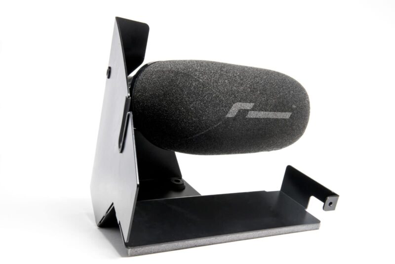 Close-up of a black foam-covered microphone mounted on a metal stand (podcast/recording setup).