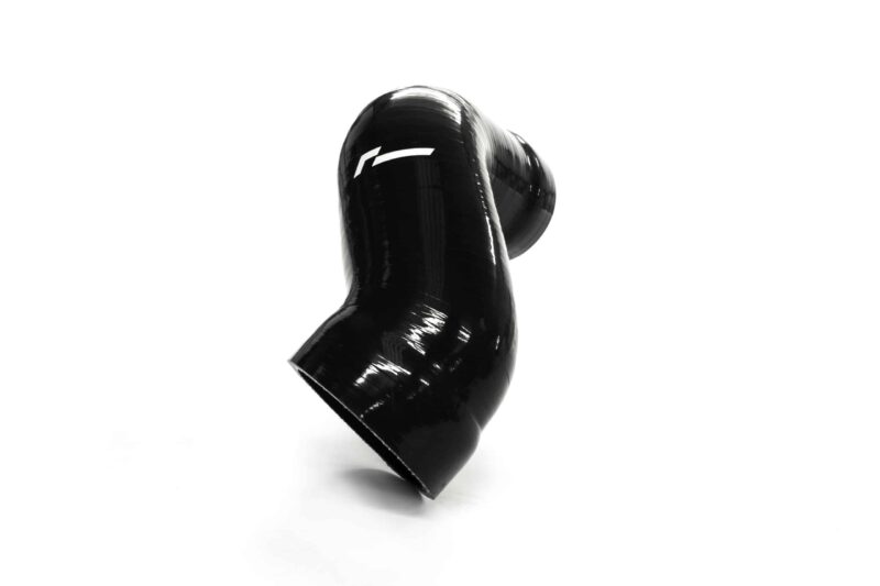Glossy black boxing glove floating against a white studio backdrop.