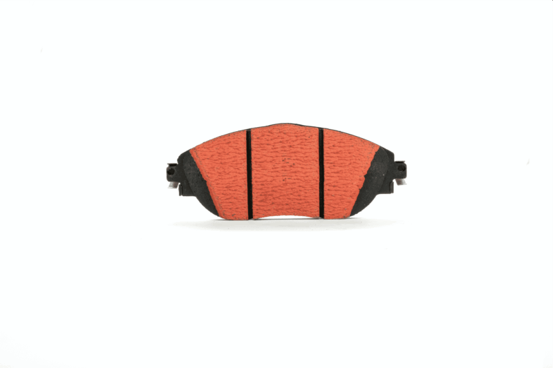 Front view of an orange brake pad with black backing and metal connectors on the sides, against a white background.