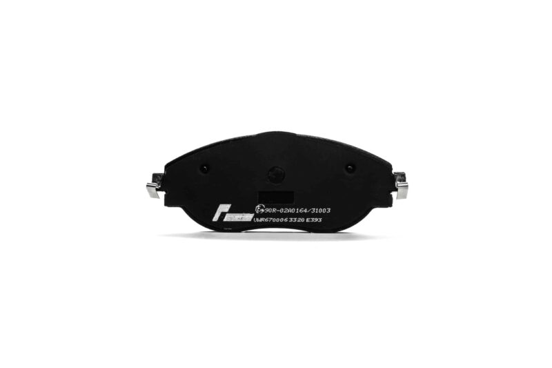 Black curved brake pad with metal mounting clips on either end, white etched markings visible on surface.