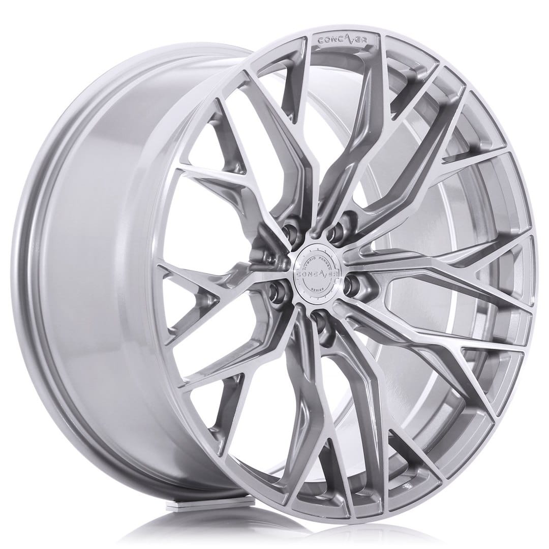 53683_0_39356jpg - OPSHOLDERS Shiny silver multi-spoke alloy car wheel rim photographed at an angle, showing detailed design and central hub