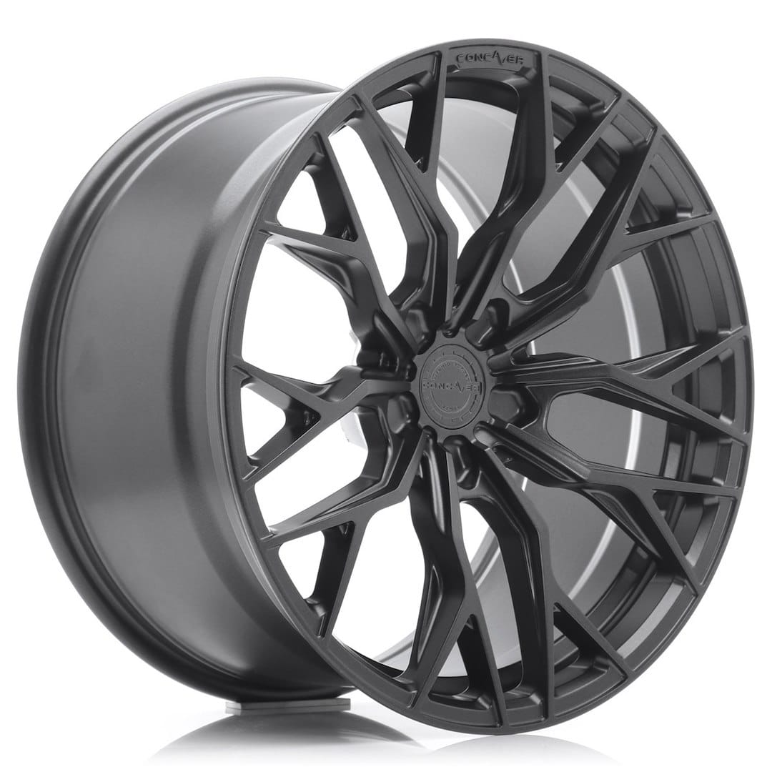 53685_0_39358jpg - OPSHOLDERS Black glossy alloy wheel with an intricate multi-spoke design, shown at an angle to highlight the spokes and center hub