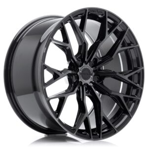 Glossy black multi-spoke alloy wheel with a silver inner lip and a central hubcap design.