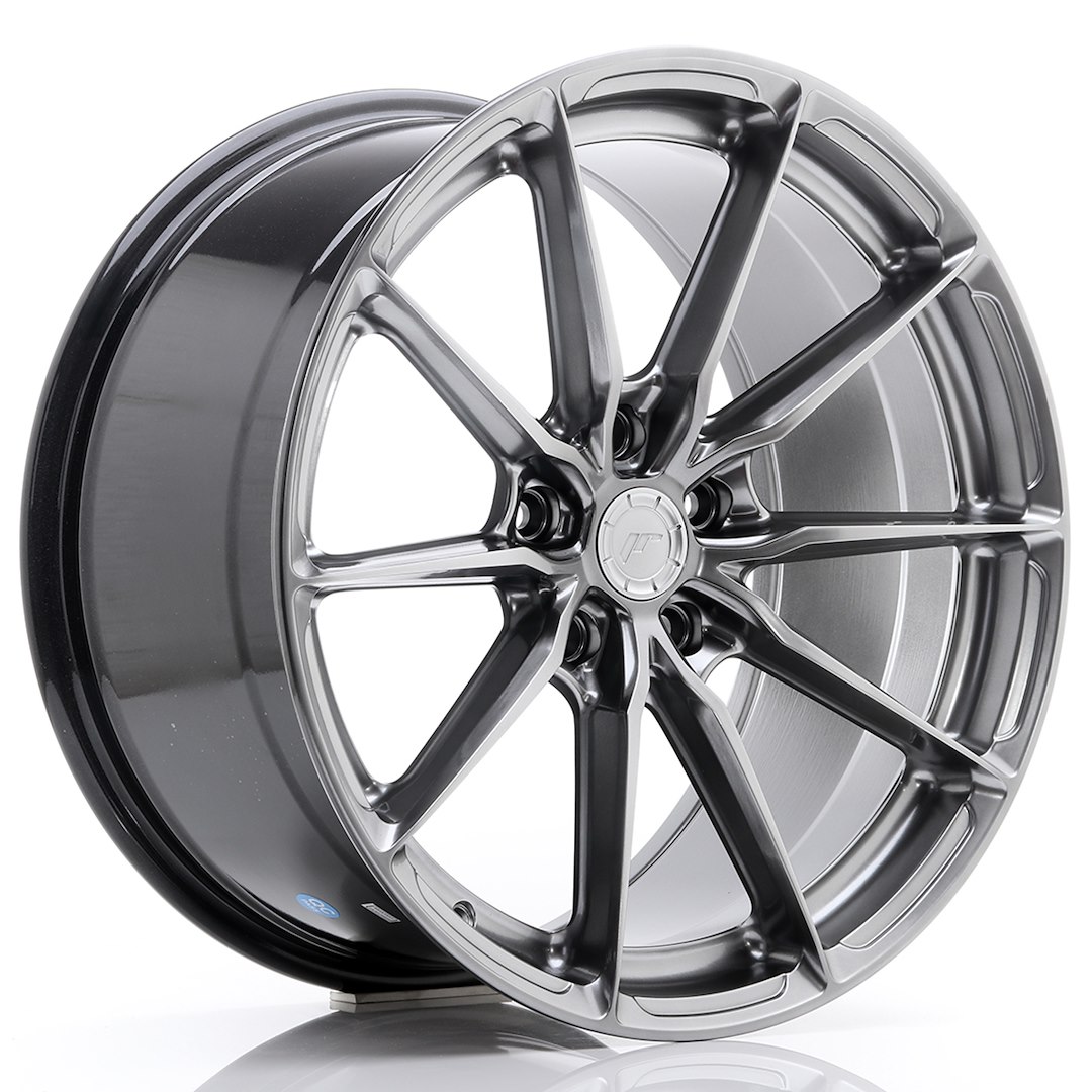 54090_0_39374jpg - OPSHOLDERS Shiny metallic alloy car wheel with a ten-spoke design and a central hub cap with a logo, set against a white background.