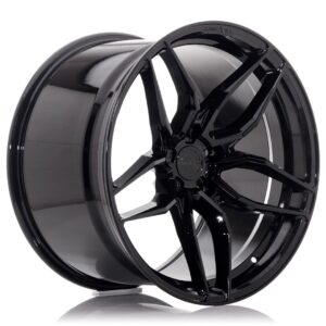 Gloss black aftermarket car wheel with a multi-spoke design, shown at an angle against a white background