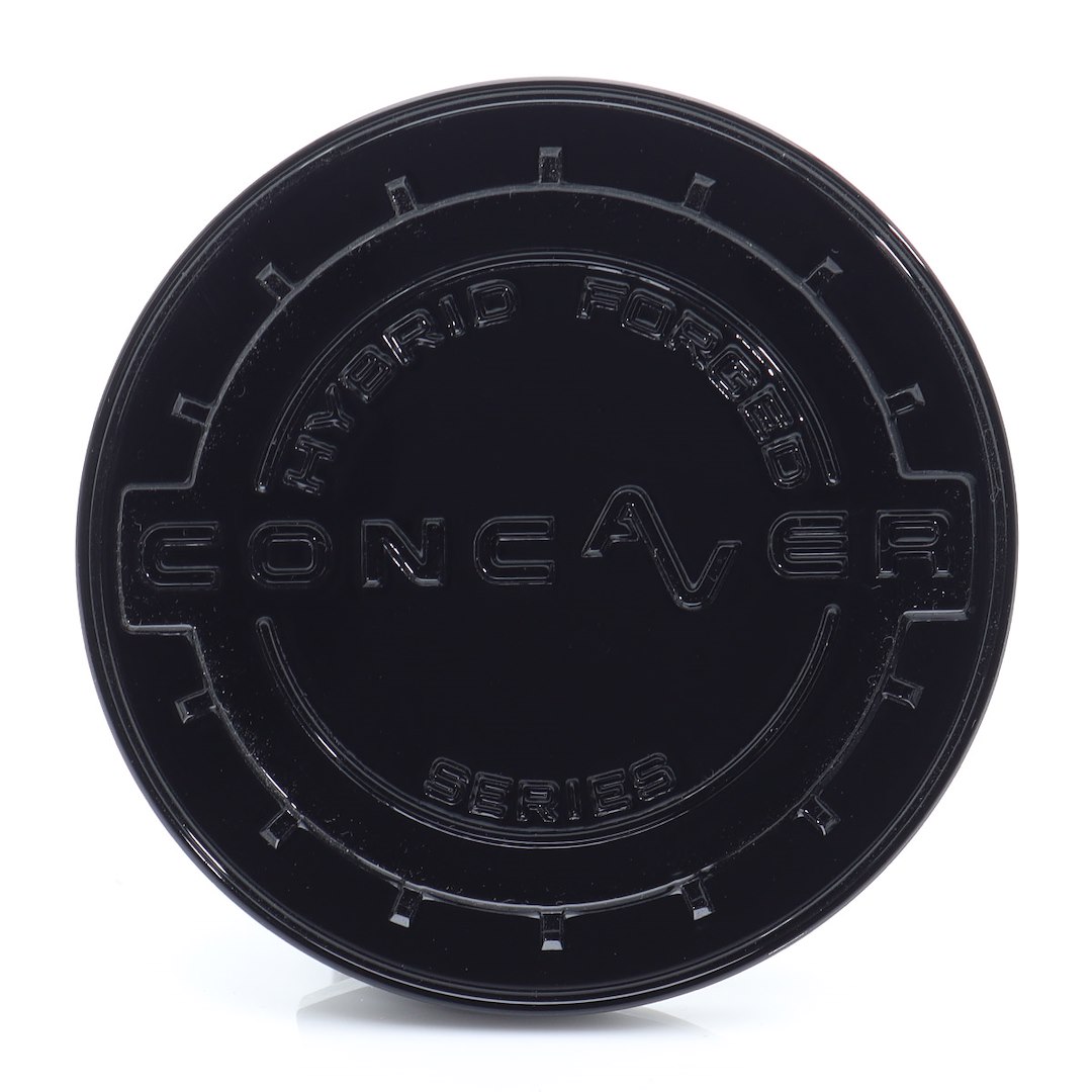 55309_0_39666jpg - OPSHOLDERS Close-up of a black round plastic cap with embossed text along the inner ring, including words like 'FORGED' and 'SERIES'.
