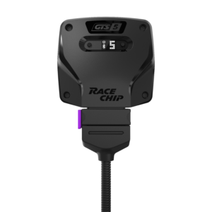 Close-up of a black RaceChip GTS5 tuner module with a lit digital display showing the number 5 and a Bluetooth icon, mounted on a stand with a purple connector.