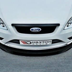 Front view of a white Ford car in a parking lot, showing a Maxton Design license plate and grille detail.