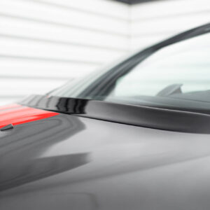 Close-up of a grey car hood with a red stripe and windshield in the background.