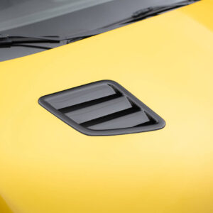 pol_po_Bonnet-Vents-459_6jpg - OPSHOLDERS Close-up of a bright yellow car hood with a black vent and nearby wiper blades visible on the windshield edge