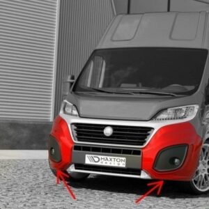 Front three-quarter view of a gray van with a bright red lower bumper on a cobblestone surface.