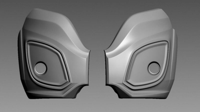 Two symmetrical gray 3D sculpted shell pieces facing each other, each with a recessed circular detail and layered contours.