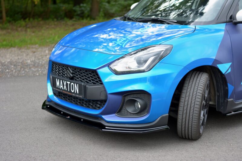 pol_po_FRONT-SPLITTER-V-1-suitable-for-Suzuki-SWIFT-6-SPORT-8268_5jpg - OPSHOLDERS Blue Suzuki front-end: hood, headlight, and grille visible with license plate 'MAXTON' front and center.