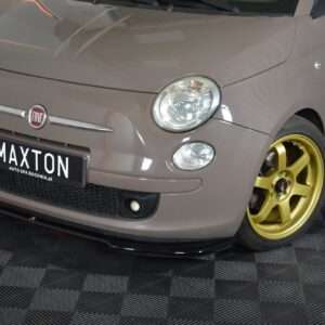 Front view of a beige Fiat hatchback with a gold alloy wheel, displayed in a showroom.