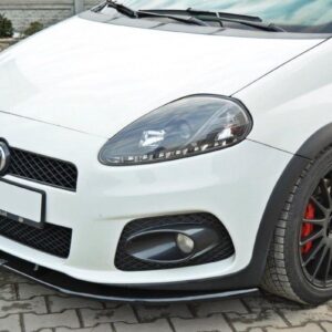 White sporty hatchback front view with black alloy wheels and red brake calipers on a brick driveway