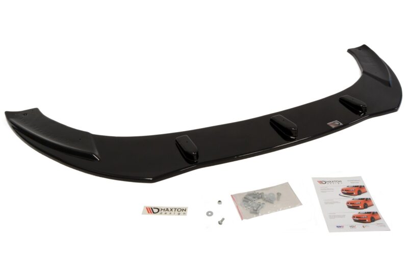 Glossy black rear car spoiler with three mounting feet and installation hardware laid out nearby