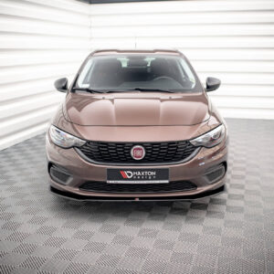 Front view of a brown Fiat car parked indoors against white striped walls in a showroom.