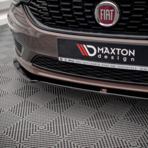 Close-up of a Fiat car front with a black Maxton design plate, chrome badge, and honeycomb grille visible.