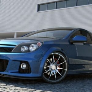 Blue sporty hatchback with large alloy wheels parked on cobblestone driveway in front of a modern industrial building; visible Brabus-style front bumper and grill details (Maxton design).